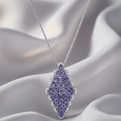 Purple gemstone pendant necklace on a soft fabric background 18K gold tanzanite diamond necklace flatlay – luxury fine jewelry by Tresor Collection