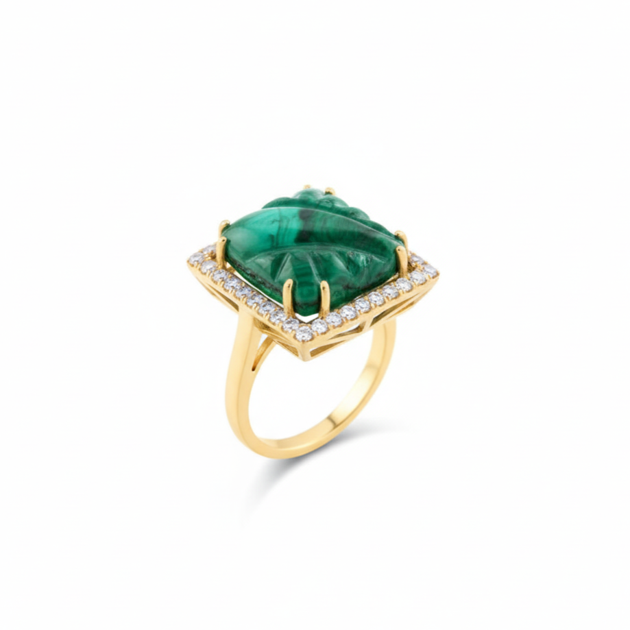 Gold ring with a green gemstone on a white background 18K gold emerald and diamond ring flatlay – luxury fine jewelry by Tresor Collection 