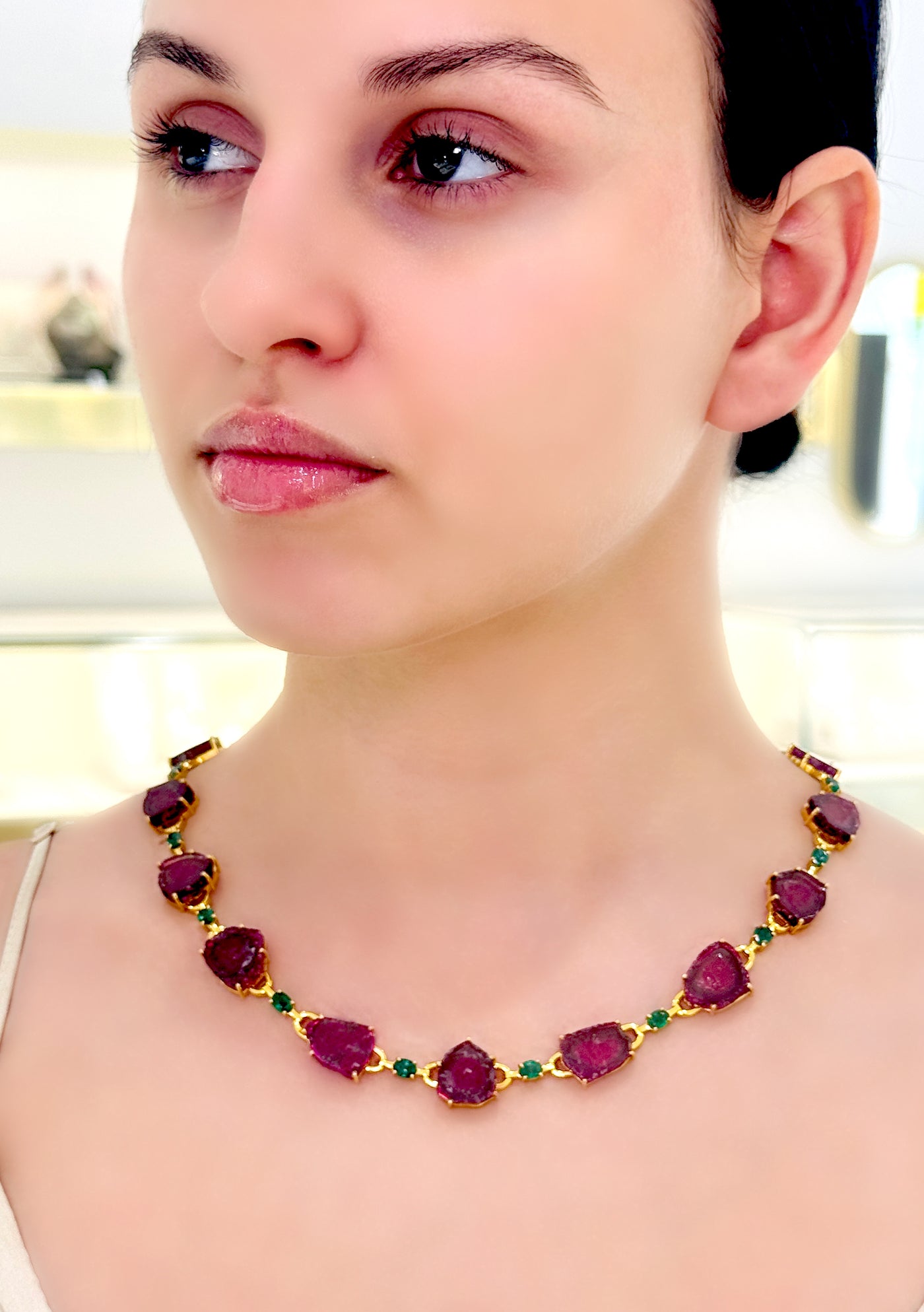 Emerald Oval & Watermelon Tourmaline U/S Necklace In 18K Yellow Gold - Tresor Collection Gold necklace with bi-color tourmaline gemstones worn on model – vibrant pink-green gemstone design