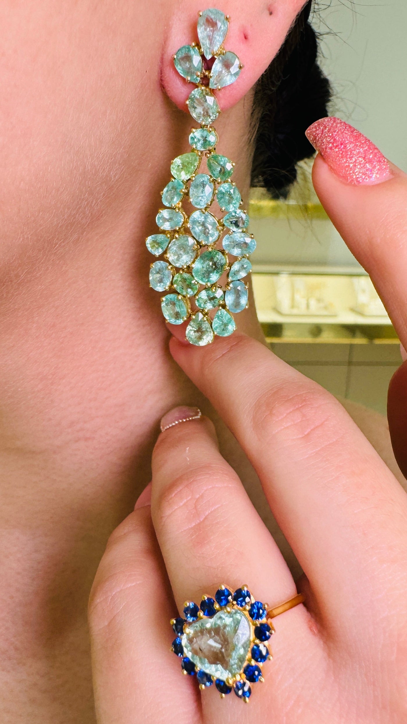 Paraiba Tourmaline Heart shape And Blue Sapphire Round Ring In 18K Yellow Gold - Tresor Collection Lifestyle shot of Paraiba tourmaline heart ring accented with blue sapphires – premium fine-jewelry styling