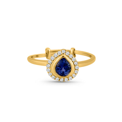 18K gold pear-cut blue sapphire ring – designer jewelry 18K gold blue sapphire and diamond ring flatlay – luxury fine jewelry by Tresor Collection