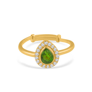 Gold bracelet with a green teardrop gemstone and diamond accents on a white background 18K gold tsavorite and diamond ring flatlay – luxury fine jewelry by Tresor Collection