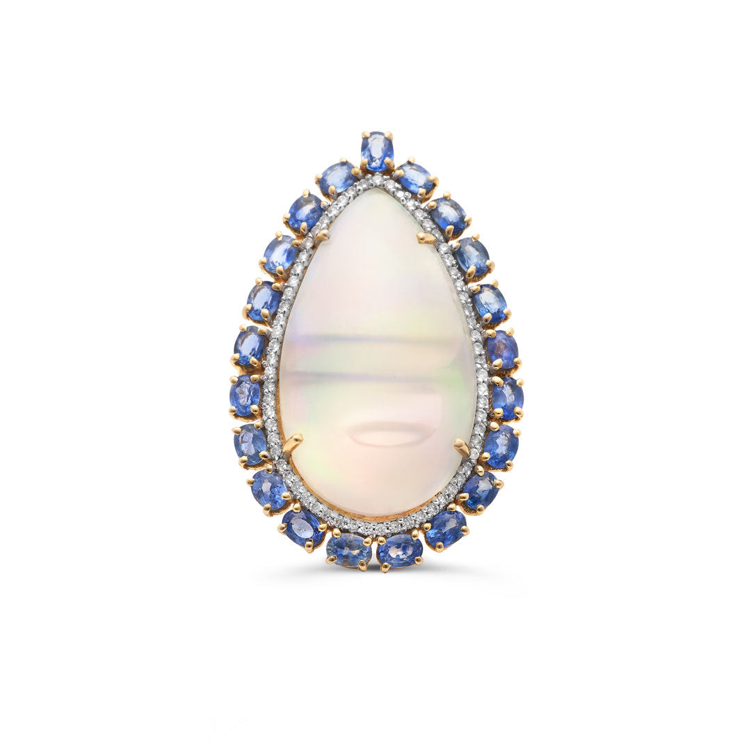 A pear-shaped opal ring with blue sapphires and diamonds set in 18K yellow gold. 18K gold Ethiopian opal and sapphire ring flatlay – luxury handcrafted jewelry by Tresor Collection