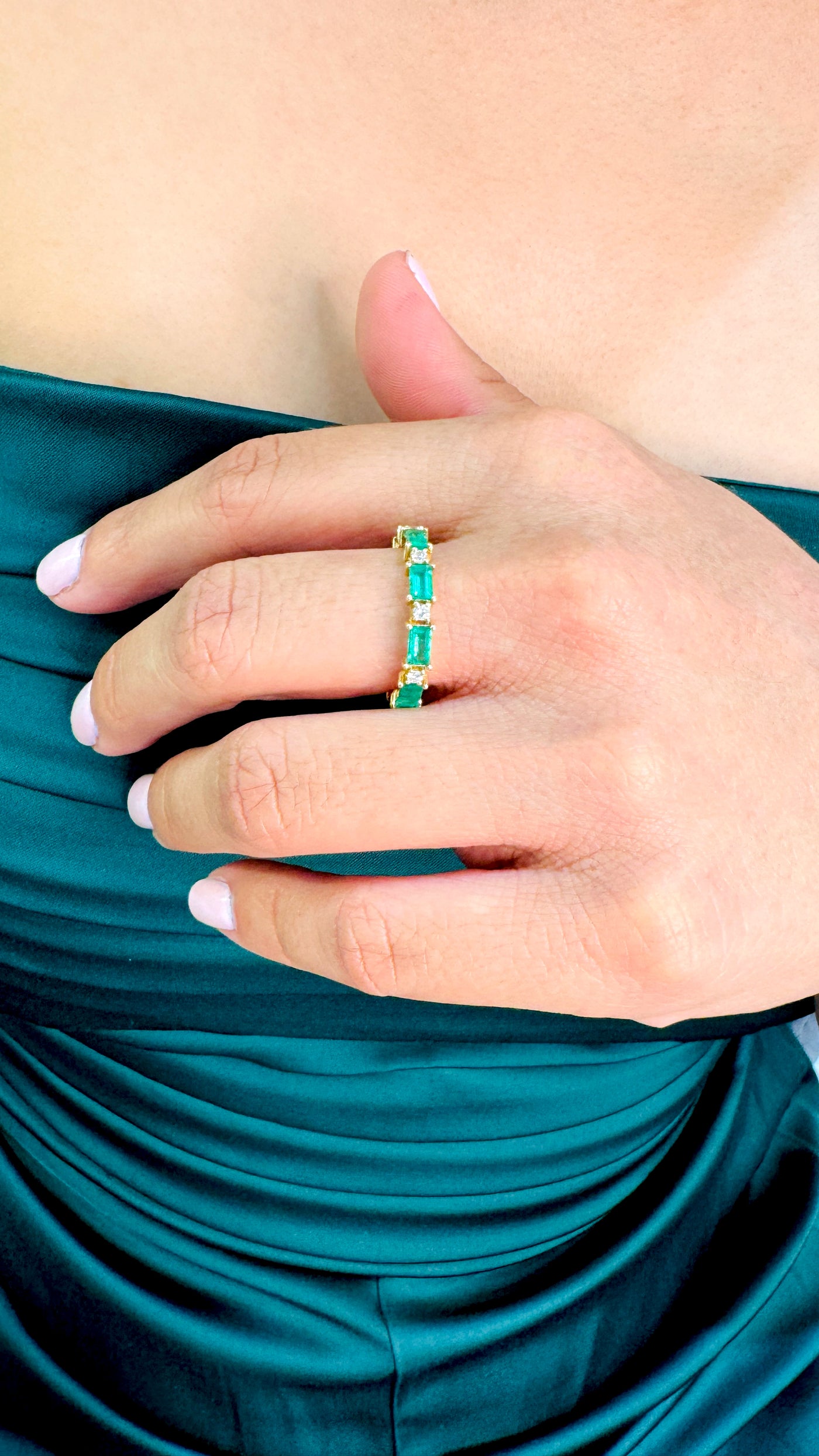 Emerald Rectangle And Diamond Ring In 18K Yellow Gold - Tresor Collection Close-up of emerald eternity band ring on model – elegant handcrafted fine jewelry
