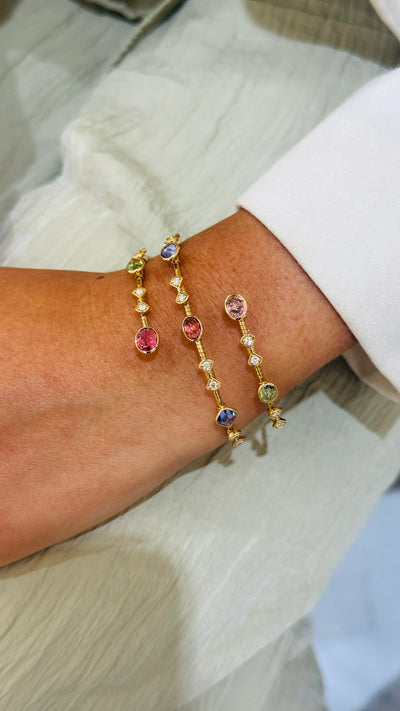 18K gold multi-gemstone bangle in a relaxed lifestyle setting – modern fine jewelry by Tresor Collection
