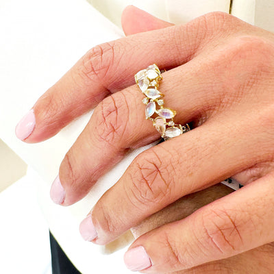 Rainbow Moonstone & Diamond Ring In 18K Yellow Gold - Tresor Collection Close-up of gold rainbow moonstone ring worn on hand – shimmering pear-cut stones in a floral design
