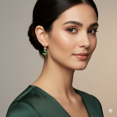 Woman wearing green earrings with a neutral background