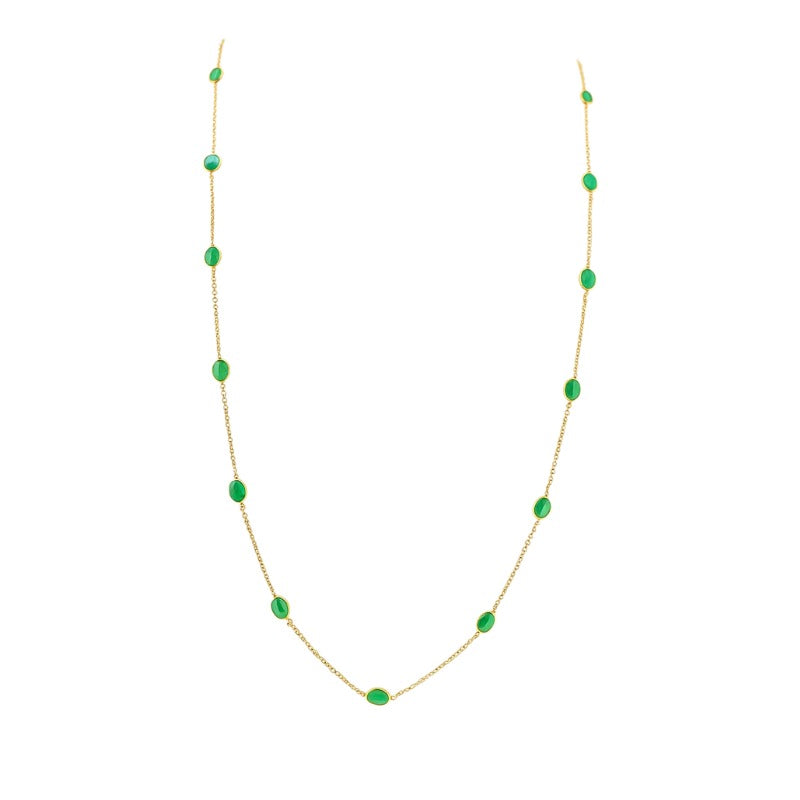 18K gold emerald station necklace flatlay – luxury fine jewelry by Tresor Collection
Gold necklace with green gemstones on a white background