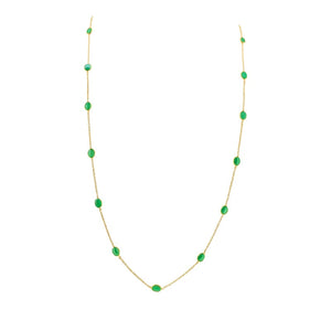 18K gold emerald station necklace flatlay – luxury fine jewelry by Tresor Collection
Gold necklace with green gemstones on a white background