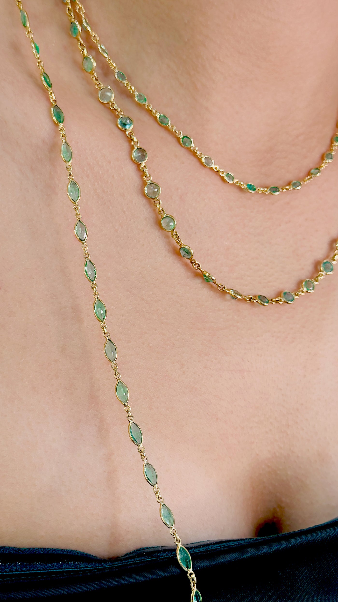 Emerald Marquise Necklace In 18K Yellow Gold - Tresor Collection Model wearing green emerald necklace – displaying the necklace’s luxurious appeal and vibrant emerald stones.