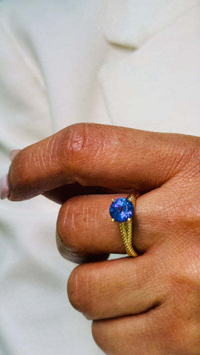 Tanzanite Round Ring In 18K Yellow Gold - Tresor Collection Model wearing gold tanzanite ring – showing the ring as part of an elegant fashion statement.