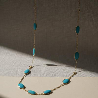 Necklace with turquoise beads on a neutral background 18K yellow gold turquoise necklace close-up – modern classic jewelry by Tresor Collection