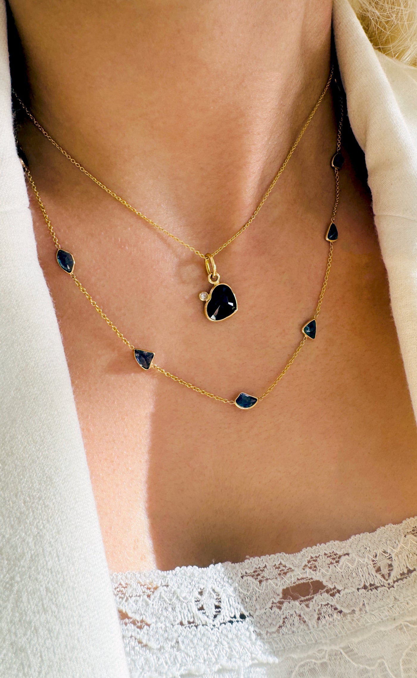 18K Gold Multishape Blue Sapphire Necklace – Fin Collection - Tresor Collection Gold black sapphire heart pendant necklace worn on model – elegant and modern fine jewelry