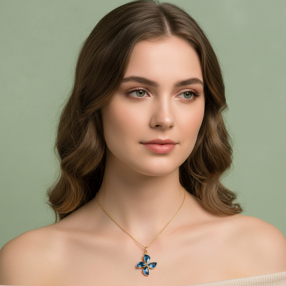 Woman wearing a necklace with a blue pendant against a green background Model wearing London Blue Topaz flower pendant necklace – elegant high-end jewelry look