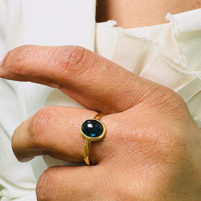 Blue Sapphire Oval Ring In 18K Yellow Gold - Tresor Collection Blue Sapphire solitaire ring shown in natural light – timeless handcrafted 18K gold jewelry