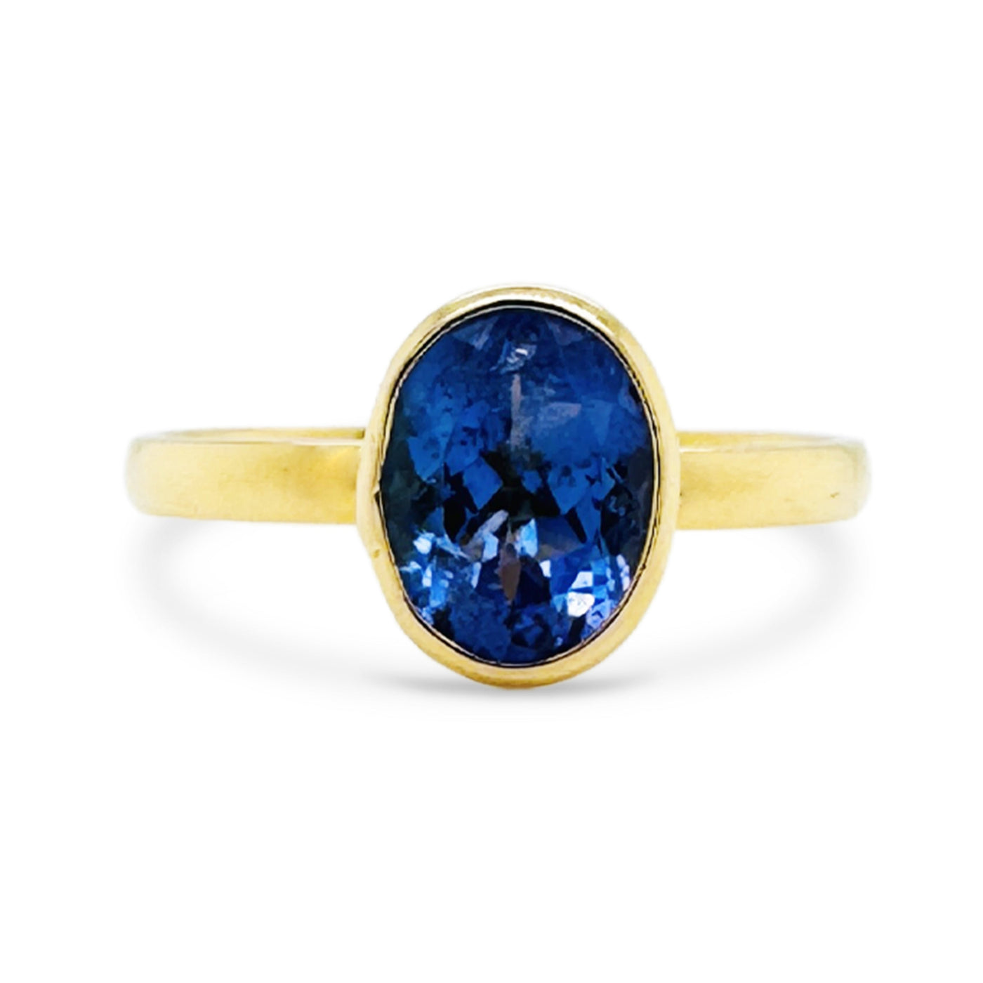 18K gold tanzanite ring flatlay – oval-cut blue gemstone fine jewelry by Tresor Collection