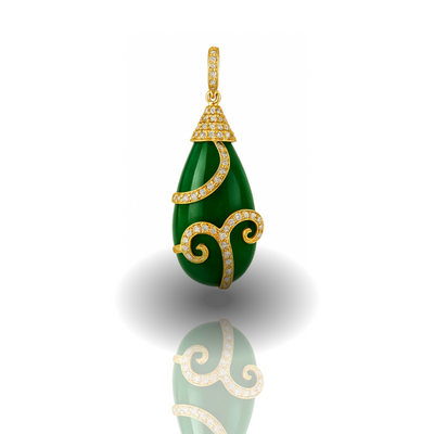 Green teardrop pendant with gold accents on a white background 18K yellow gold emerald pendant close-up – modern classic jewelry by Tresor Collection