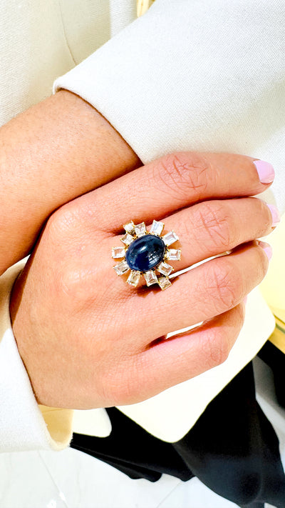 Blue Sapphire And White Topaz Rings In 18K Yellow Gold - Tresor Collection Elegant Blue Sapphire and Diamond cocktail ring worn on hand – fine gold jewelry with baguette diamonds