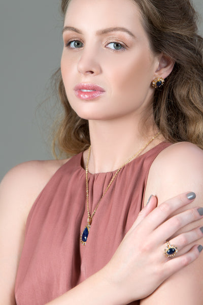 Blue Sapphire And White Topaz Rings In 18K Yellow Gold - Tresor Collection Model showcasing Blue Sapphire and Diamond statement ring – fine jewelry handcrafted in gold