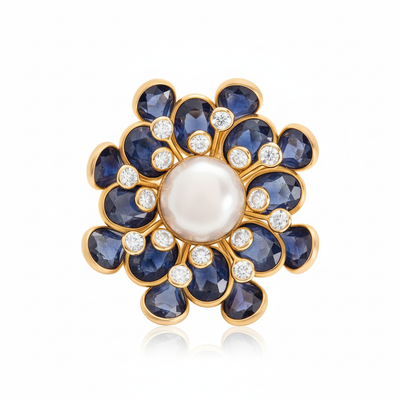 Jewelry item with blue stones and a pearl center on a white background