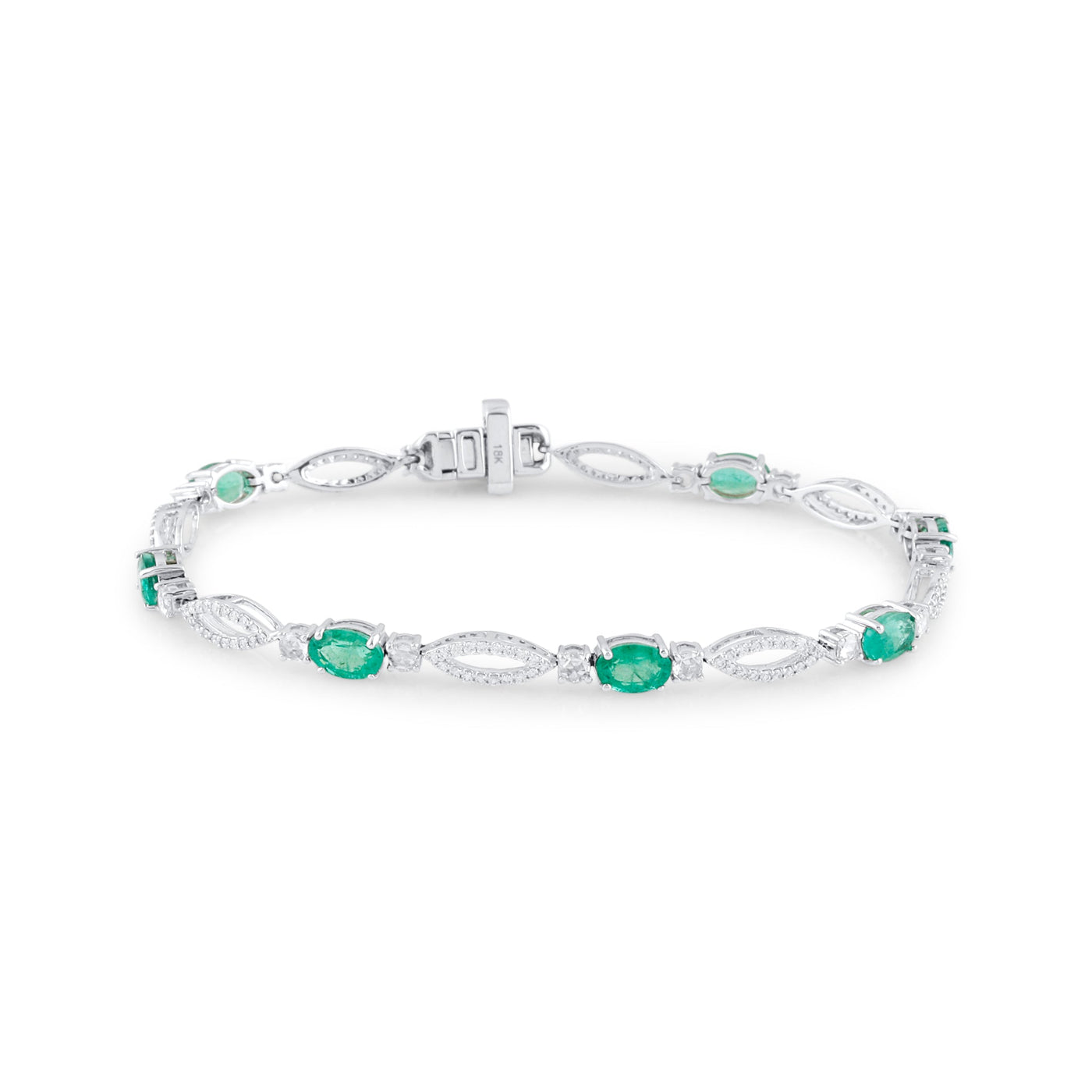 18K White Gold Oval Emerald & Diamond Bracelet by Tresor Collection 18K white gold emerald and diamond tennis bracelet flatlay – luxury handcrafted jewelry by Tresor Collection