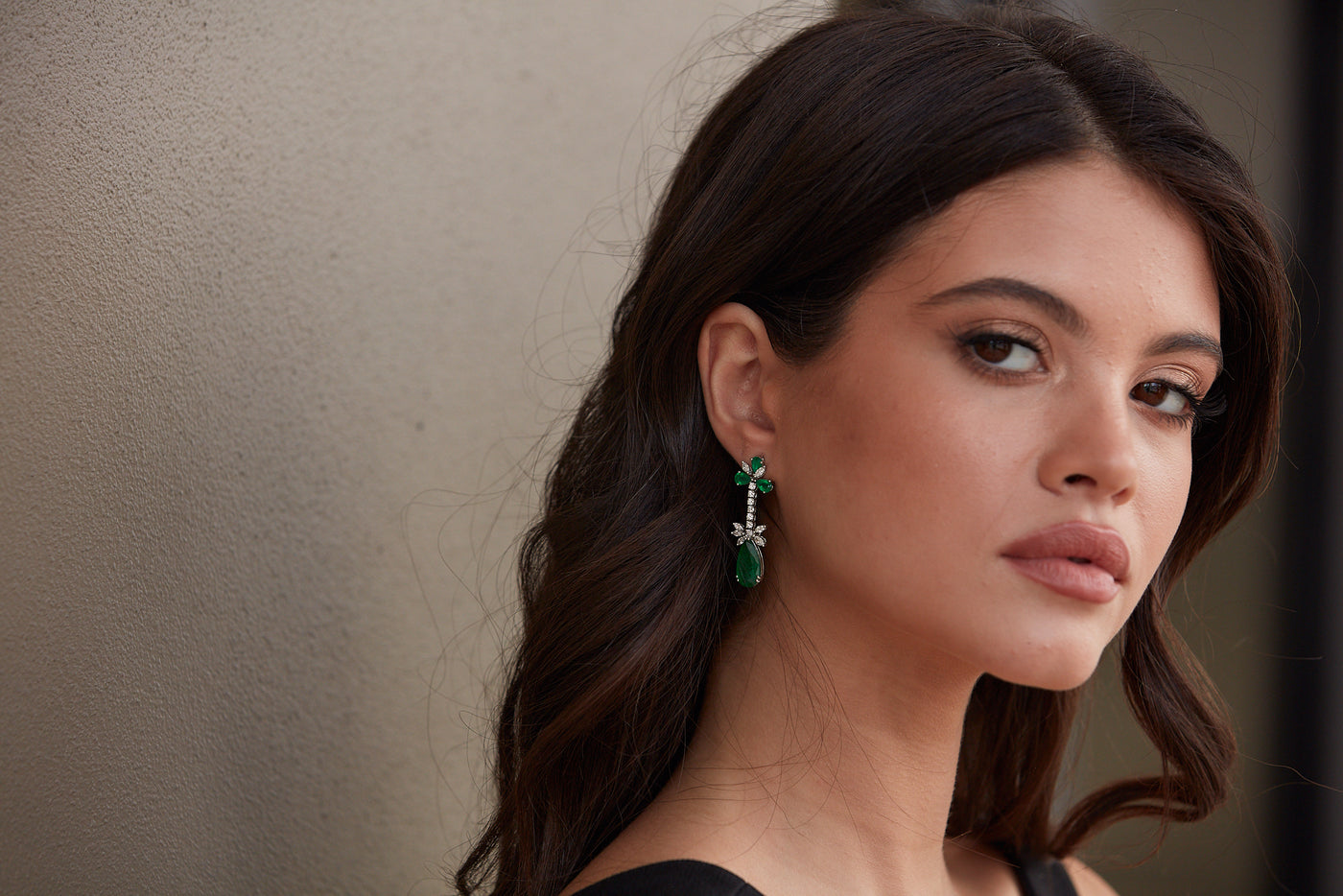 Emerald P/S & Diamond Earring In 18K White Gold - Tresor Collection Model wearing emerald and diamond floral drop earrings – elegant fine jewelry styling