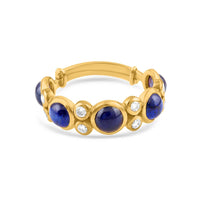 Gold ring with blue gemstones and clear stones on a white background 18K gold blue sapphire and diamond ring flatlay – luxury fine jewelry by Tresor Collection