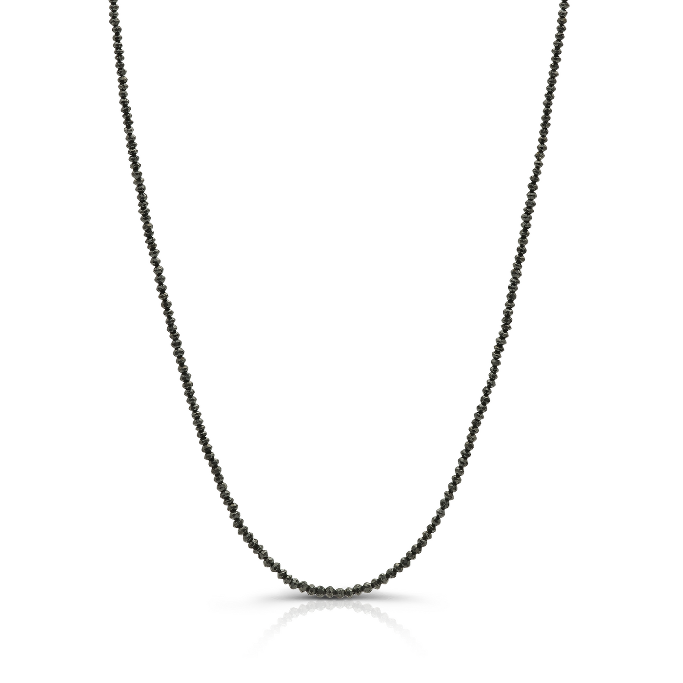 Close-up of 18k yellow gold necklace with 15.58 cts black diamond beads on white background. 18K gold black diamond bead necklace flatlay – luxury fine jewelry by Tresor Collection