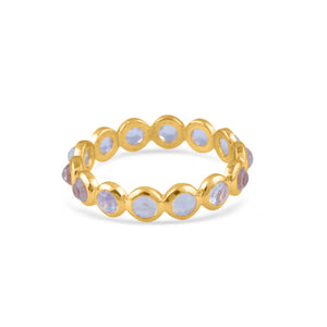 Gold ring with purple gemstones on a white background 18K gold rainbow moonstone eternity ring flatlay – luxury fine jewelry by Tresor Collection