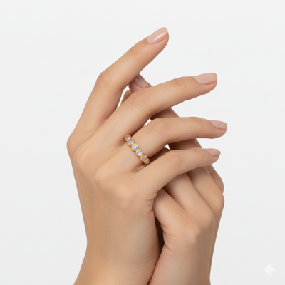 Hand wearing a delicate ring with small stones on a light background Rainbow moonstone gold ring styled for gifting and festive wear – luxury handcrafted jewelry from Tresor Collection