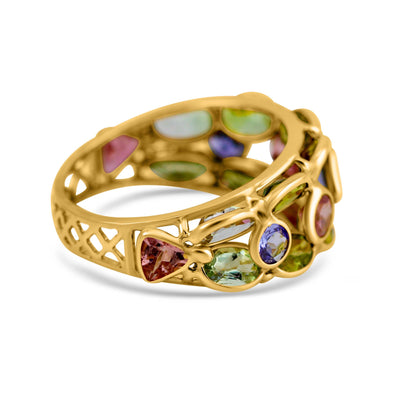 Gold ring with multicolored gemstones on a white background Multicolor gemstone ring styled for festive occasions – luxury handcrafted jewelry from Tresor Collection