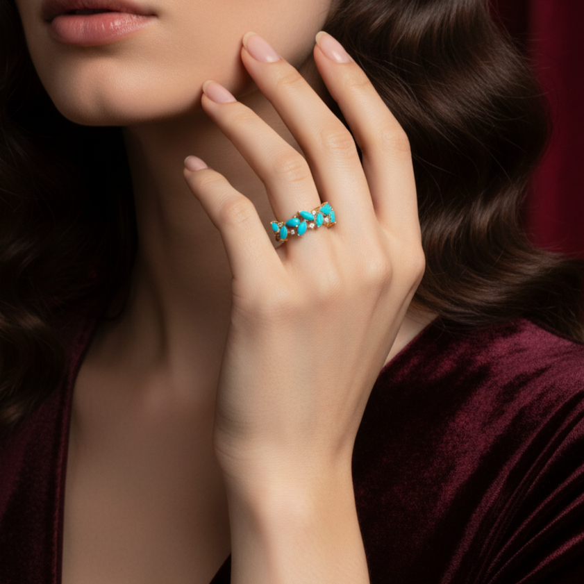 Close-up of a woman's hand wearing a turquoise ring with a blurred background Turquoise ring styled for festive occasions – luxury handcrafted jewelry from Tresor Collection