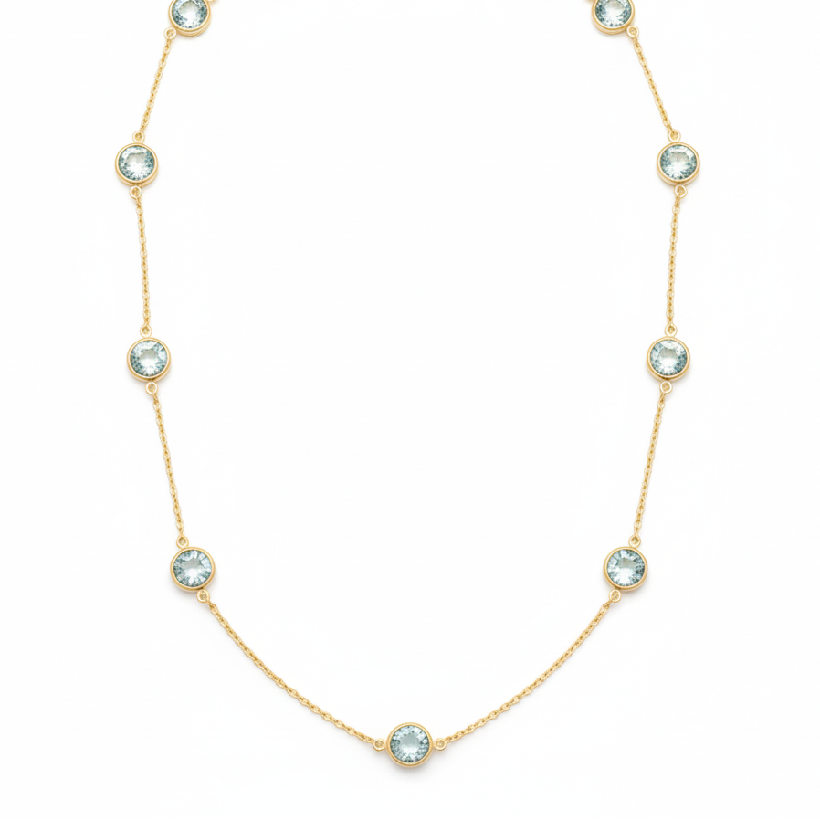 Gold necklace with crystal-like stones on a white background 18K gold aquamarine necklace flatlay – luxury fine jewelry by Tresor Collection