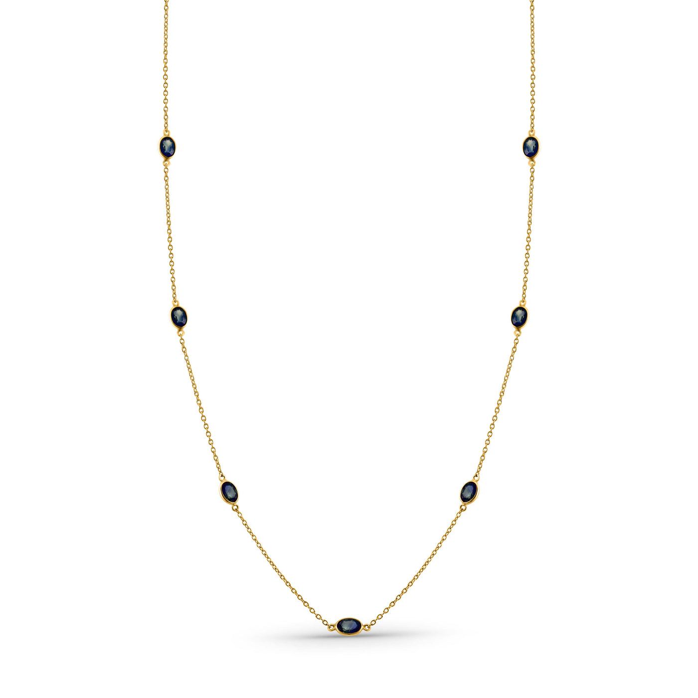Gold necklace with black beads on a white background 18K gold blue sapphire necklace flatlay – luxury fine jewelry by Tresor Collection