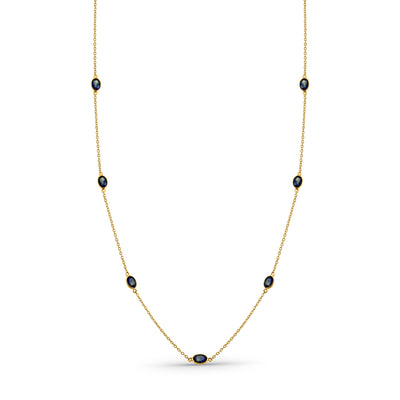 Gold necklace with black beads on a white background 18K gold blue sapphire necklace flatlay – luxury fine jewelry by Tresor Collection