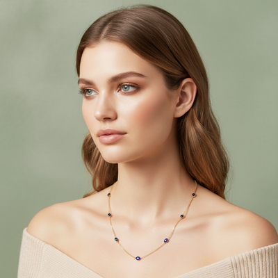 Woman wearing a delicate necklace against a plain background  Elegant blue sapphire gold necklace on model – designer gold jewelry for women by Tresor Collection