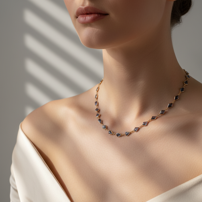 Necklace worn by a person in a beige top with a neutral background Elegant blue sapphire necklace on model – designer gold jewelry for women by Tresor Collection