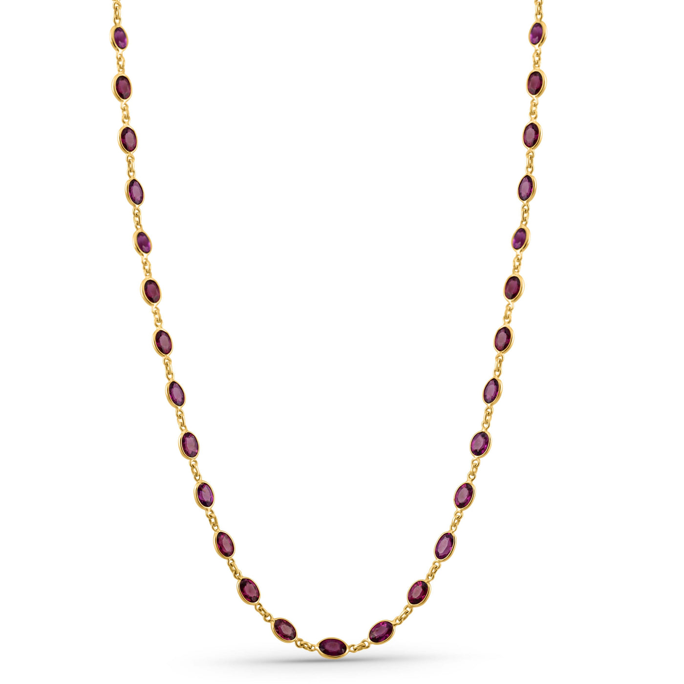 Gold necklace with red gemstones on a white background 18K gold rhodolite necklace flatlay – luxury fine jewelry by Tresor Collection