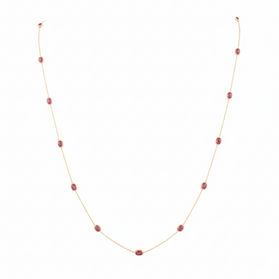 Necklace with red beads on a white background 18K gold ruby necklace flatlay – luxury fine jewelry by Tresor Collection