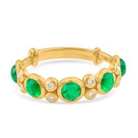 Gold bracelet with green gemstones and diamonds on a white background 18K gold emerald and diamond ring flatlay – luxury fine jewelry by Tresor Collection