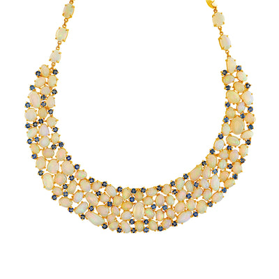 A yellow gold necklace featuring alternating ethiopian opal and blue sapphire gemstones. 18K gold Ethiopian opal and sapphire necklace flatlay – luxury handcrafted fine jewelry by Tresor Collection